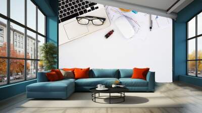 Modern White office desk table with laptop computer, eyeglasses, mouse, calculator,pen,analysis chart or graph and cup of coffee.Top view with copy space.Working desk table concept. Wall mural