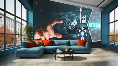 Outsourcing Global Recruitment Business and internet concept, Person hand touching outsourcing icon on virtual screen with blue bokeh background. Wall mural