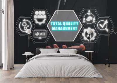 Total quality management concept, Businessman hand holding total quality management icon on virtual screen. Wall mural