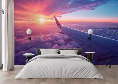 view above the clouds from the airplane window, airplane wing with beautiful sunrise horizon. Wall mural