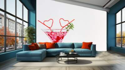 2 red straws and cocktail glass/Giant cocktail Glass with 2 heart-shaped straws and white background Concept of Valentine's day drink. Wall mural