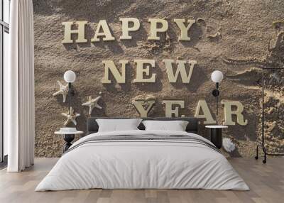 happy new year/happy new year wood sign, starfish and shellfish on the sandy beach. Wall mural