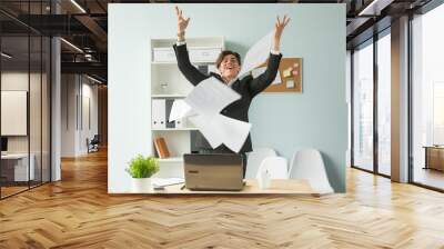 Business people, joke and fun concept - happy funny businessman throwing papers in office Wall mural