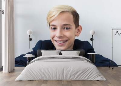 Close-up of teen boy with braces on teeth smiling on white background. Dentistry and teenager concept. Wall mural