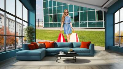 happiness, consumerism, sale and people concept - beautiful young woman with shopping bags. Wall mural