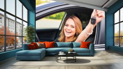 happy woman driver hold car keys in her new car Wall mural