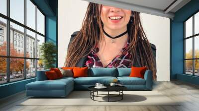 Joyful modern rock style portrait. Woman with dreadlocks and grunge style clothing and make up Wall mural