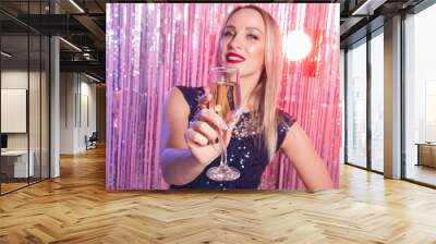 Party, drinks, holidays and celebration concept - smiling woman in evening dress with glass of sparkling wine over shiny background. Wall mural