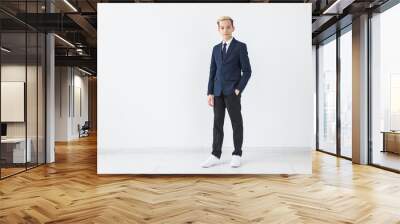 Portrait of stylish school boy teenager in white shirt and jacket against white background. Wall mural