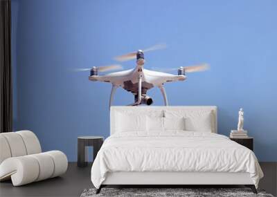 Quadcopter on a background of blue sky Wall mural