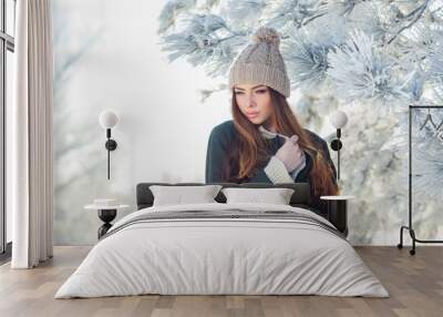 beautiful winter portrait of young woman in the snowy scenery Wall mural