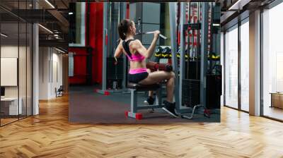 Side view of sporty muscular brunette woman doing thrust of upper block to chest Wall mural