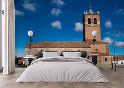 Tower and rectangular bell tower with semicircular arches built in brick and stone base. Church in Pajares de Adaja in Castilla y León Wall mural