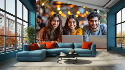 Group of young indian professionals with laptop in a cafe. Wall mural