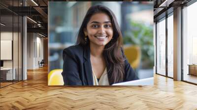 Portrait of a young indian woman working in office. Wall mural