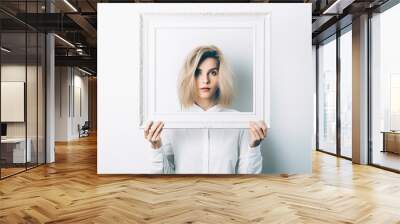 A woman holding up a picture frame white background Wall mural