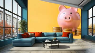 piggy bank with coins on yellow background with copy space Wall mural