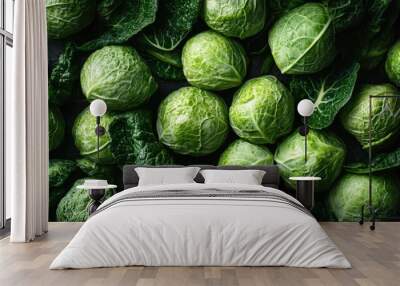 A heap of green cabbage, with a few leaves missing, highlighting the fresh, organic quality of the vegetables Wall mural