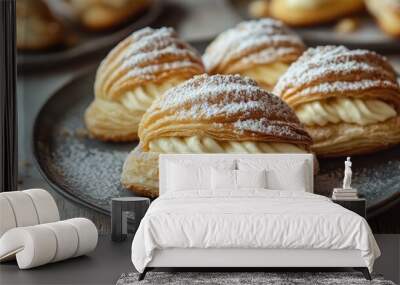 A plate of cream-filled pastries dusted with powdered sugar, ready to be enjoyed as a sweet treat Wall mural