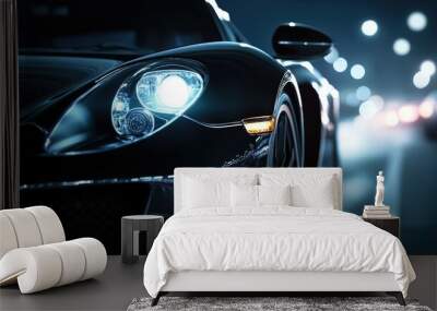 Close-up of a luxury sports car's headlamp at night, illuminating the road ahead with a powerful, sleek design Wall mural