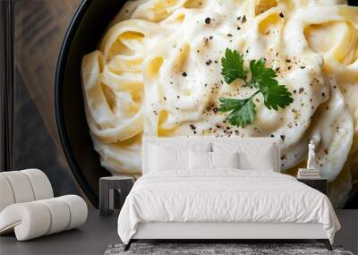 Creamy Alfredo pasta dish, captured from the top, showcasing its rich texture and appetizing appearance Wall mural