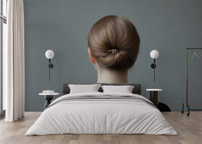 Decorative hair clip seen from behind on a young woman, set against a smooth gray backdrop. Wall mural