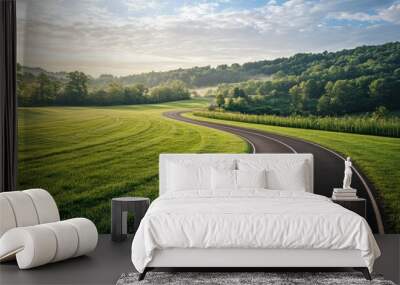 Empty running lanes on a track surrounded by green grass, with a beautiful morning sky. Wall mural