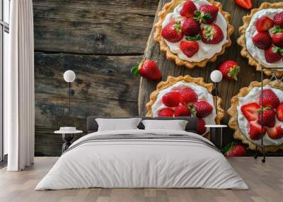 Homemade strawberry shortcake pies displayed on a rustic wooden table, fresh berries and cream ideal for a natural dessert party. Wall mural