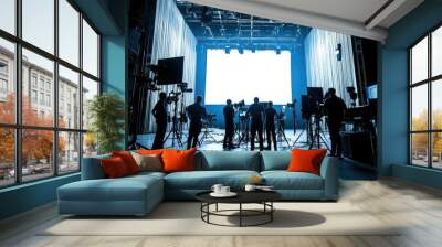 Silhouette of crew members in a high-tech film studio, working with professional set and lighting equipment for a commercial. Wall mural