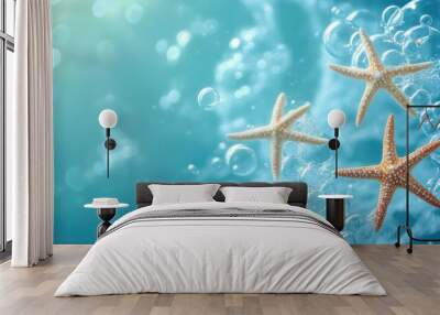 Soft blue background with three starfish and rising bubbles, capturing a tranquil ocean theme Wall mural