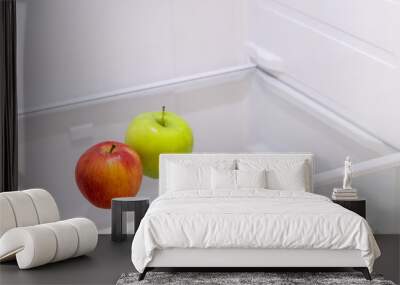 two apples green and red on a shelf in an empty refrigerator Wall mural