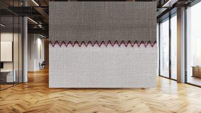 white and grey fabric stitched with a zigzag purple thread. Stitched pieces of fabric close-up. zigzag stitch. Wall mural