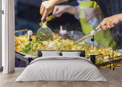 asian street food - people cooking some food in seoul - south korea. noodle with vegetables Wall mural