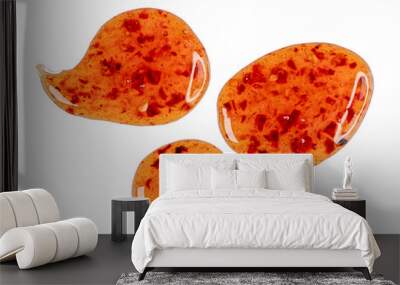 Drops of sour sweet sauce with pieces chilli pepper isolated on white, top view Wall mural