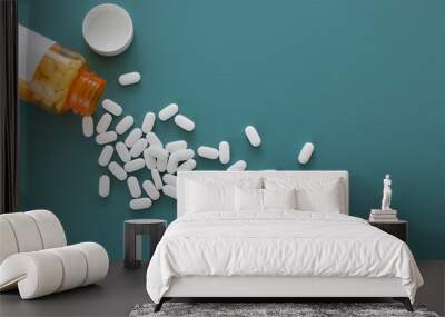 white pills on a teal background Wall mural