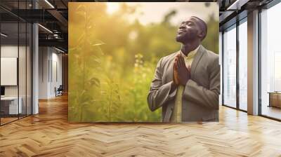 African guy offering thanksgiving while surrounded by greenery. GENERATE AI Wall mural