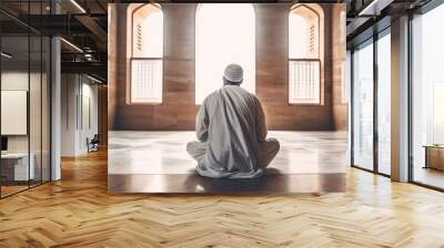 photograph of a Muslim pilgrim sitting in a mosque while dressed for the Hajj.  GENERATE AI Wall mural