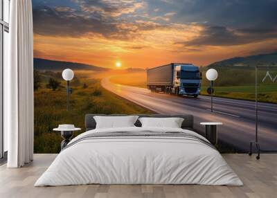 The setting sun creates a warm, golden glow over the rural fields as the truck moves along the asphalt road. Wall mural