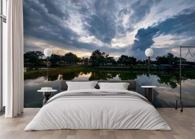 Water reflection of cloudy sky at amazing sunset Wall mural