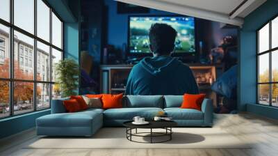 a handsome gamer guy gaming on his pc computer console with keyboard mouse and headphones in front of multiple monitor. sitting on a chair in his gaming room with rgb led lights. Generative AI Wall mural