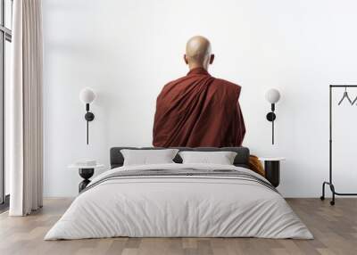 a photo of a bald buddhist monk with orange robe sitting in the lotus pose, isolated on white background. praying and meditating. photo from behind his back. Generative AI Wall mural