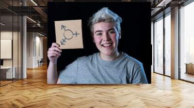 Portrait of happy proud and confident trans teenager man holding transgender symbol Wall mural