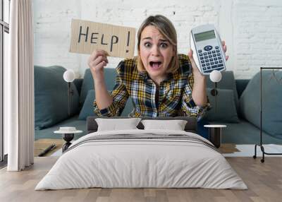 Portrait of stressed and overwhelmed young woman trying to manage home finances paying bills Wall mural