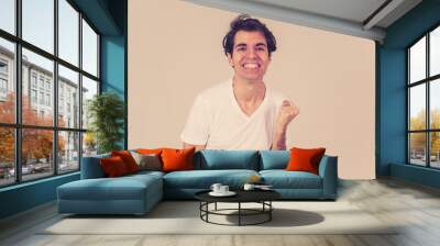 Portrait of surprised and happy man celebrating victory and winning lottery in human emotions Wall mural