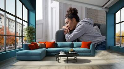 Sad black woman suffering from depression symptoms feeling distressed alone at home Wall mural