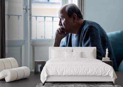 Sad unhappy old senior man suffering from memory loss and alzheimer feeling depressed and lonely Wall mural