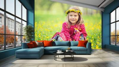 Portrait of happy little girl in spring park Wall mural