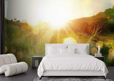 Beautiful sunrise in the mountain..Meadow landscape refreshment with sunray and golden bokeh. Wall mural