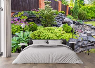 Landscape design of home garden. Beautiful stone landscaping in backyard in summer. Wall mural