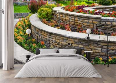 Landscaping with retaining walls and flowerbeds in residential house backyard Wall mural